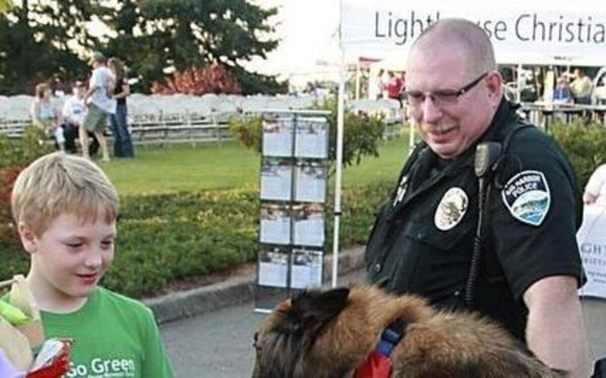 
Gig Harbor police officer Mike Allen with his K-9 friend, Pistol, entertains guests at the 2014 National Night Out event.

