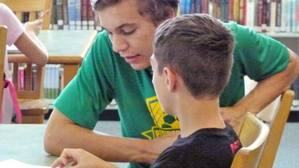 Peninsula soccer player Mason Haubrich tutors Harbor Ridge Middle School student Cole Drill. Haubrich started the mentoring program as a community service project last spring.