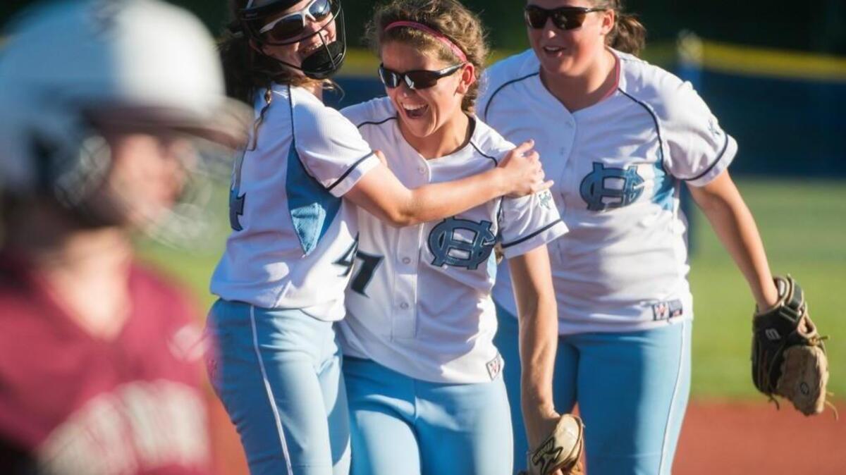 Gig Harbor's Anna Stewart (4) and Abby Nordquist (7) celebrate after a play by Nordqvist to end the third inning against Holy Names at the Regional Athletic Complex in Lacey on Friday.