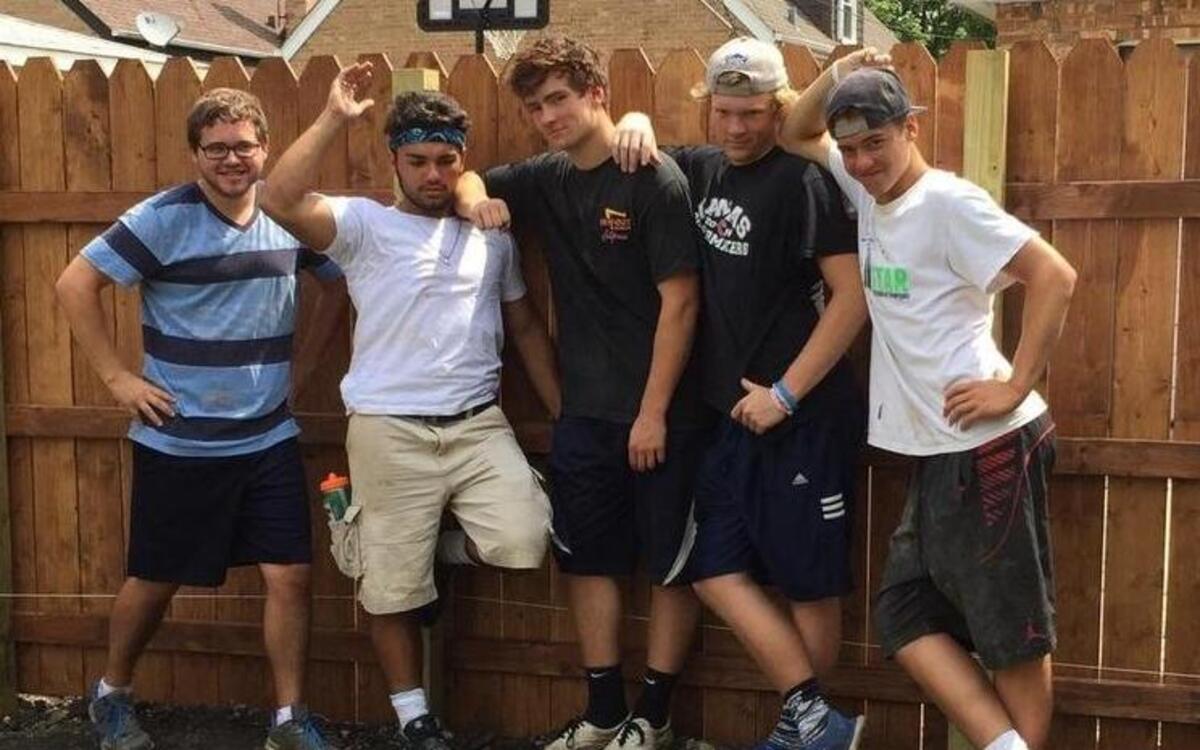 
From left, Gig Harbor High grad Ryan Small, senior football players Adrian Valona, Alex Bouterse, Andrew Johnson and Bailey Weir stand next to fence they helped build in inner city Chicago.
