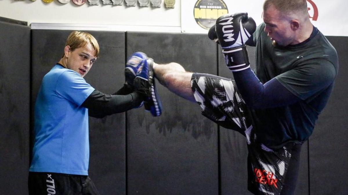 Chris Stone, left, spars with Nathan Ullevig at Gig Harbor MMA on Saturday. Stone, a Peninsula High School grad, has owned the gym for about three years and also fights professionally.