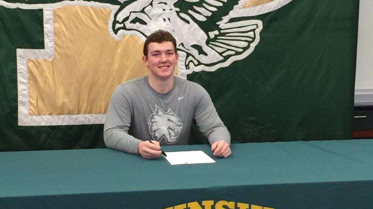 Peninsula senior offensive lineman Reece Johnson inks his letter of intent to play football at Central Washington University.