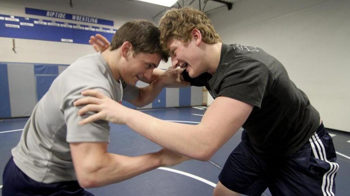 Gig Harbor High School senior wrestler Max Batanian, left, took first in the Narrows 4A league championship in the 170-pound weight class. He practices with his brother, Zach, last week at the school.