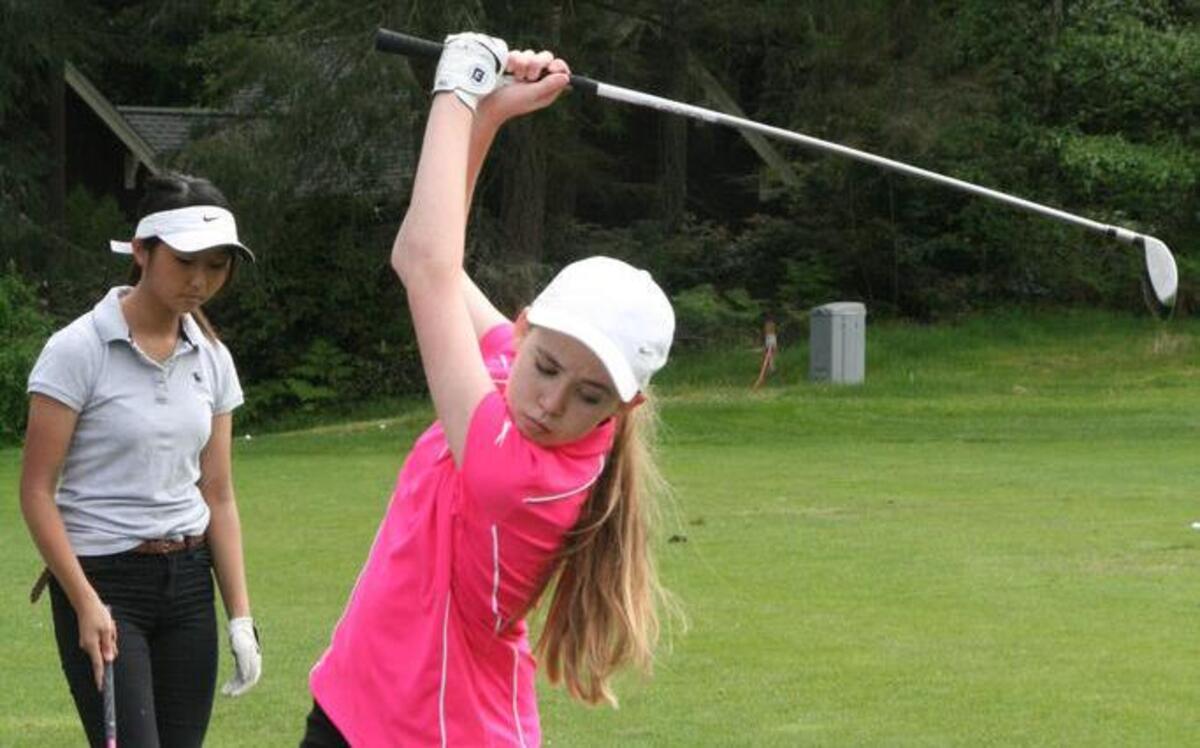 Peninsula High freshman Lauren Severn concentrates on her practice swing at Canterwood’s practice range while preparing for the state tournament.
