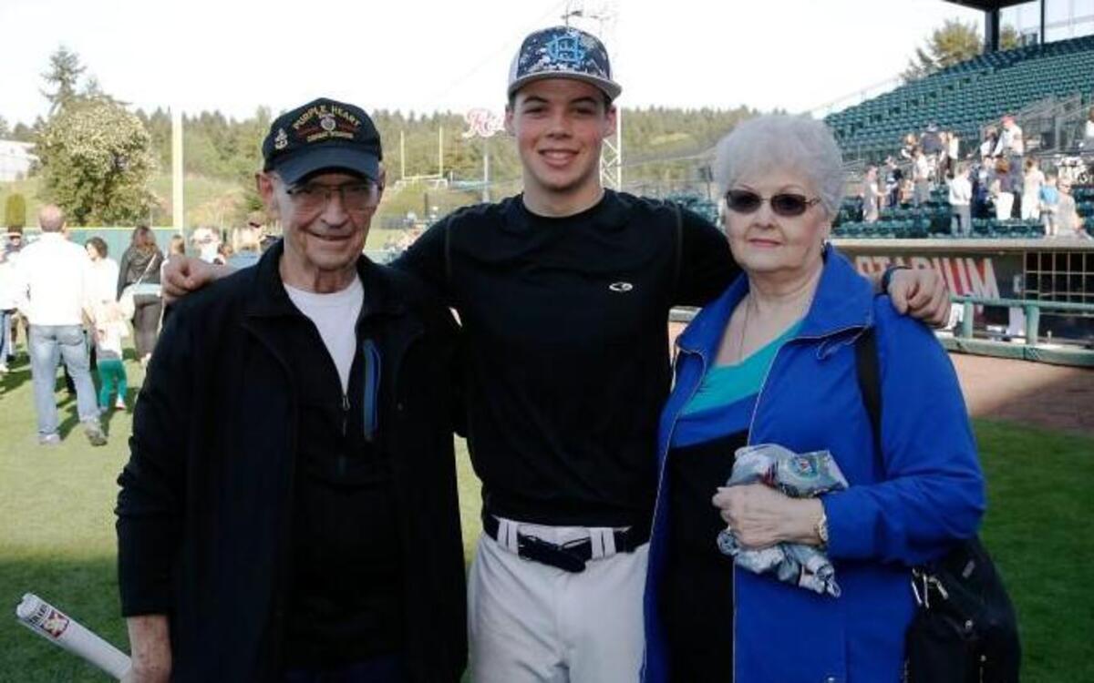 Gig Harbor High School and South Kitsap played at Cheney Stadium on Saturday afternoon to honor 48 fallen soldiers in a Tribute to Our Troops. Gig Harbor’s Logan Gerling awards the parents of fallen soldier Sgt. First Class Johnny Walls his game jersey.