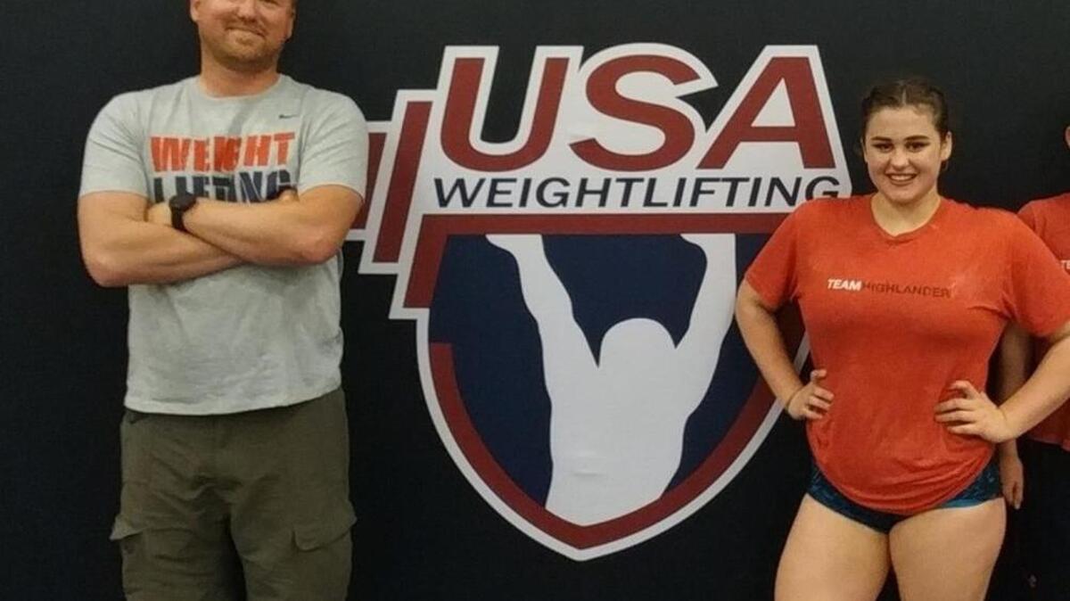 Team Highlander coach Aaron Huston, left, and 16-year-old weightlifter and Gig Harbor High School student Tatum Benson had a good time in Atlanta, where Benson took 10th in her weight class at the USA Weightlifting Junior Championships.