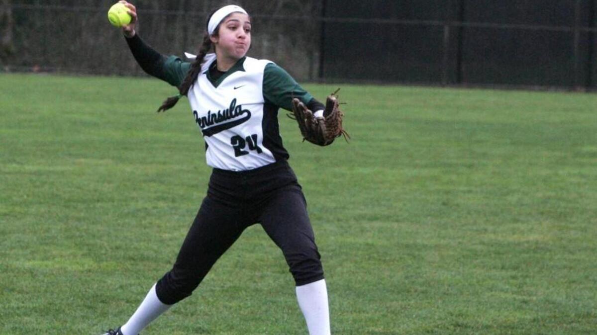 Peninsula's Audrey Krishnadasan looks to get the ball to home plate in Monday's game against Yelm.