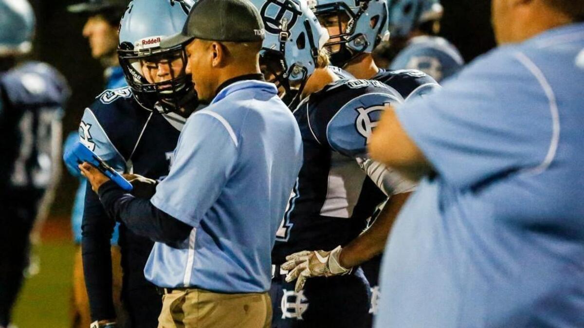 Gig Harbor junior defensive back Jake Bertram goes over a play on the iPad with defensive backs coach Nick Springer during the game.