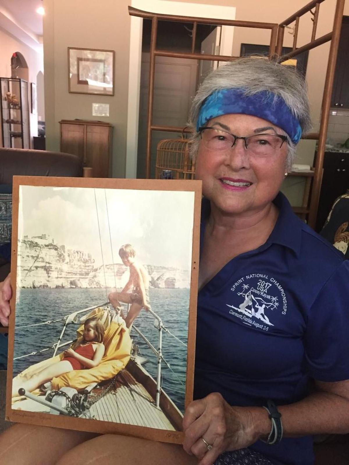 Bee Dietz, pictured in her home, holds a photo of her two children, Lark and Ben, taken while on a sailing trip in the Mediterranean Sea in 1971.