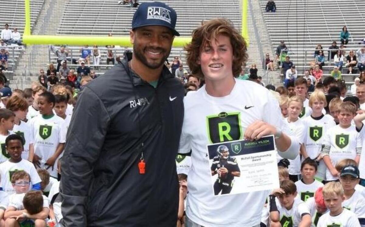 Seattle Seahawks QB Russell Wilson with Peninsula sophomore QB Burke Griffin. Griffin received the McFall Award, which is given to the individual who displayed the utmost respect, integrity and sportsmanship while relentlessly driving to become a better football player.