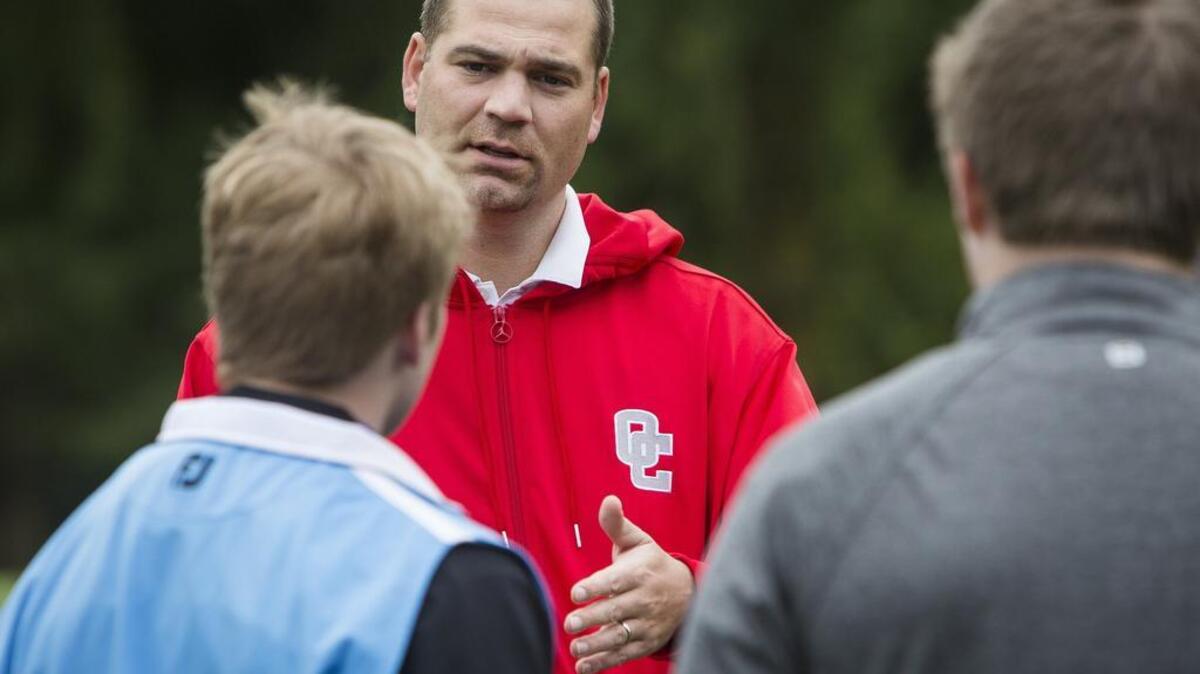 Gig Harbor boys golf coach Billy Landram speaks to the team during practice at Madrona Links in Gig Harbor on March 29.