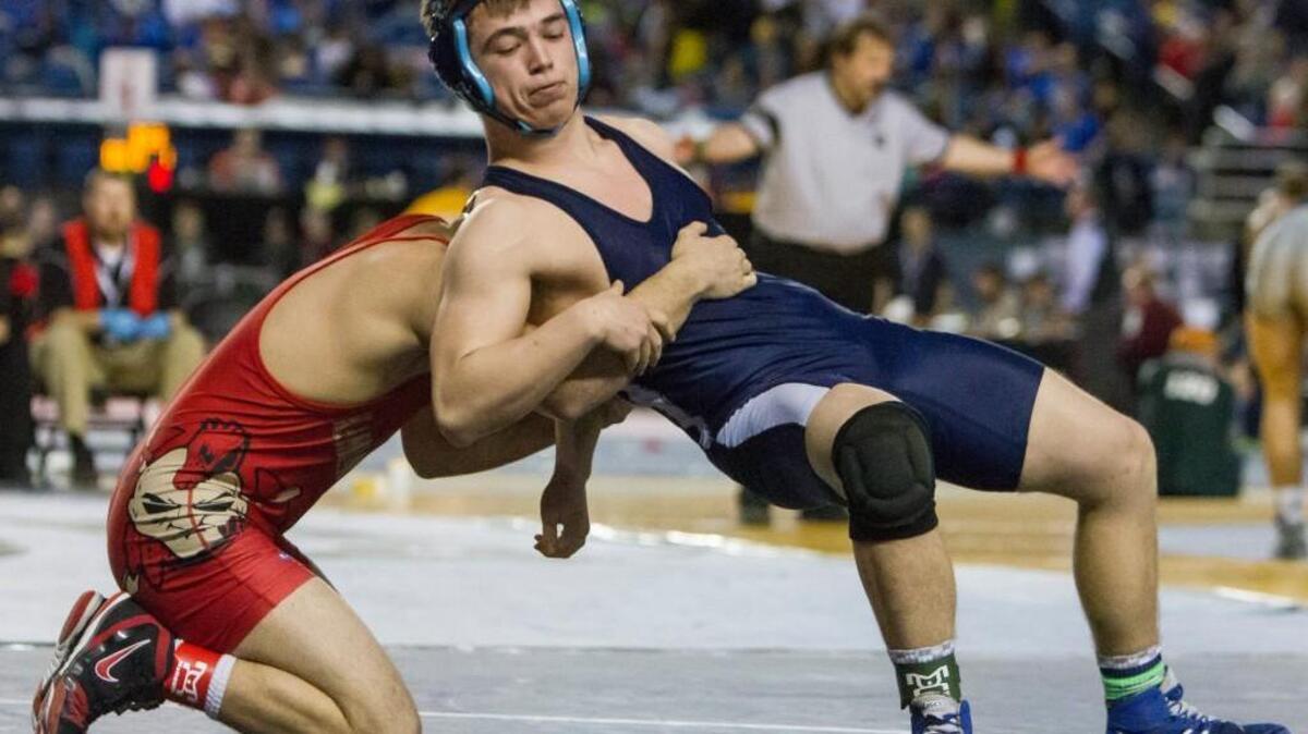 Gig Harbor’s Zayne Ball tries to escape during a match against Kamiakin’s Sione Halo during Mat Classic XXIX at the Tacoma Dome.