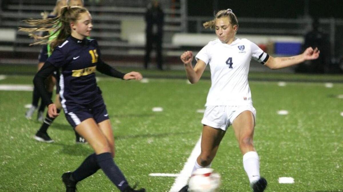Gig Harbor's Carolyn Merrick, right, controls the ball against Bellevue in the Tides' Class 3A state tournament game at Roy Anderson Field on Tuesday.