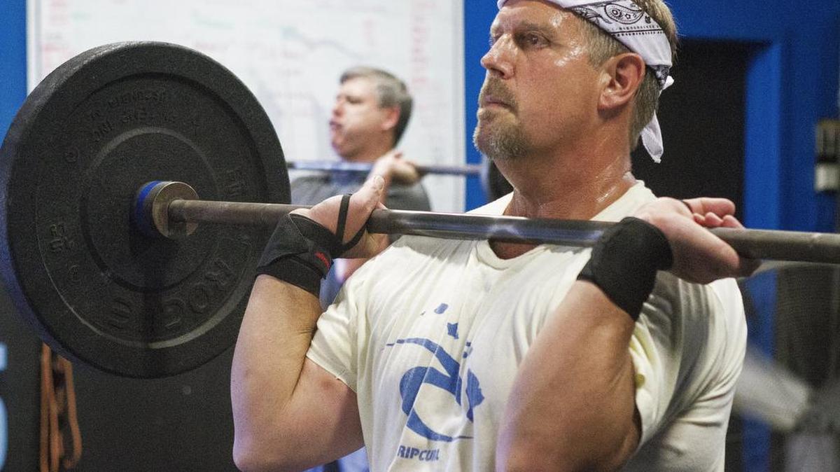 Brian Peterson does squats during a Silver Nanos session at Waypoint CrossFit in Gig Harbor on Aug. 12.