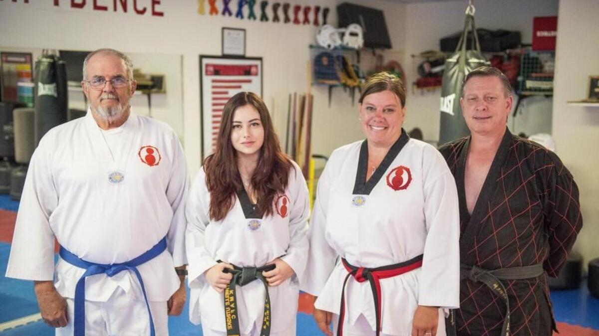 From left: Dan Utinske, Myrielle Utinski, Joanna Utinske and Master Kevin Charnley stand for a portrait at the Korean Martial Arts Family Center in Gig Harbor last week. After suffering a heart attack in 2015, Dan Utinske joined his wife and daughter in practicing taekwondo to stay fit.