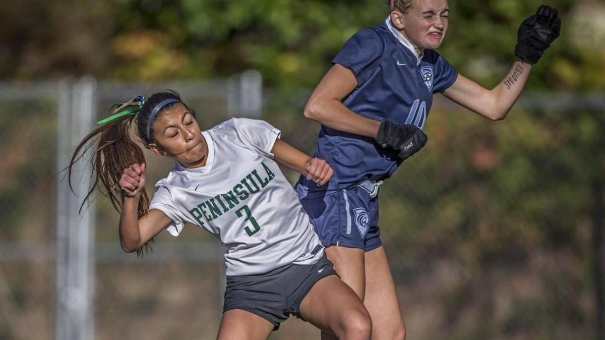 Peninsula attacker Dani Rodriguez (3) goes to the air for the ball against Tides' Hannah Carroll (10).