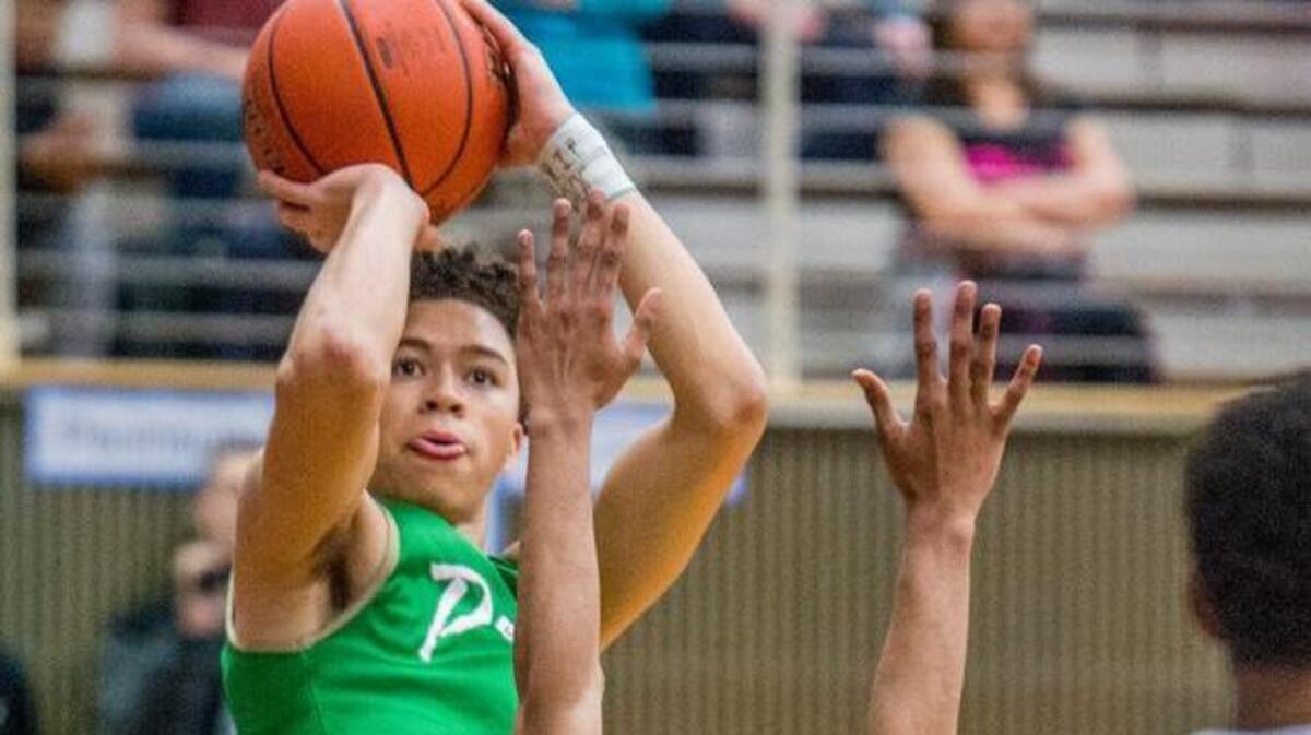 JaQuori McLaughlin of Peninsula tries a jumper in a 3A West Central District playoff boys basketball game held at Rogers High, Feb. 12. Peninsula prevailed, 68-66.