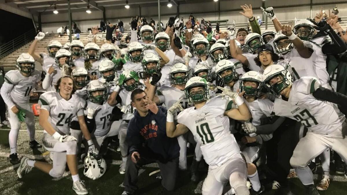 The Peninsula High School football team celebrates after beating Mountain View, 10-7, at McKenzie Stadium in Vancouver, Wash. in the opening round of the Class 3A state tournament.