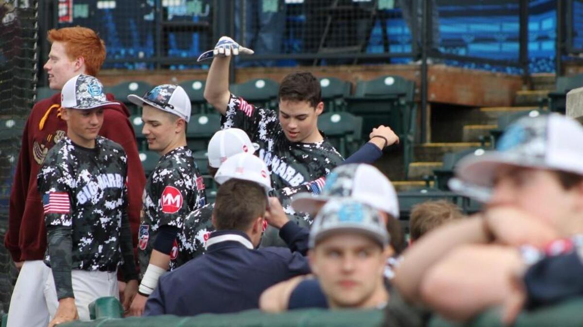 Gig Harbor’s Logan Gerling celebrates with his teammates after knocking in the game-winning RBI in the sixth inning against South Kitsap in the second annual Tribute to our Troops baseball game at Cheney Stadium on Saturday.