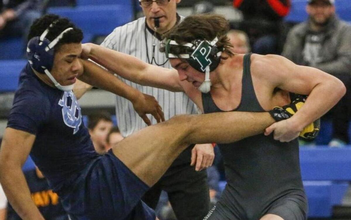 Peninsula's Seth Wahto takes down Gig Harbor's John Bittinger in the 152-pound wrestling match. Wahto came out on top in one of the night’s most exciting matches.