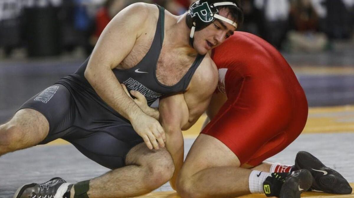 Peninsula’s Roger Kaffer wrestles Stanwood’s Arie Van Veen during Mat Classic XXIX at the Tacoma Dome.