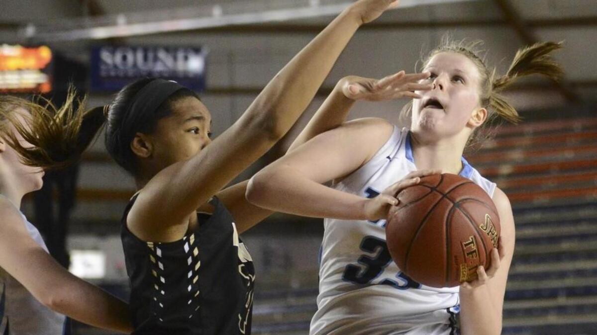 Gig Harbor’s Maddie Willet (33) puts up a contested shot in the second quarter through the defense of Lynnwood’s Kia Crawford (34). Gig Harbor played Lynnwood in a basketball game at the Tacoma Dome on Wednesday.