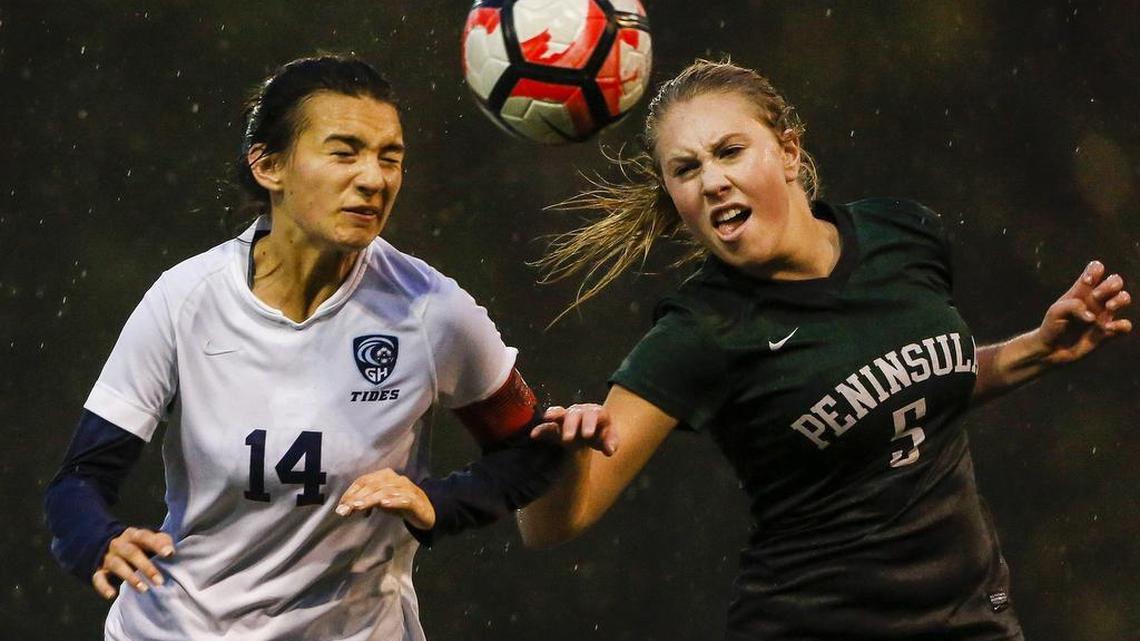 Gig Harbor’s Kaysie Bruce (14) and Peninsula’s Betsy Brunkow (5) fight for possession in the first half. Gig Harbor defeated Peninsula, 8-0, on Thurday at home.