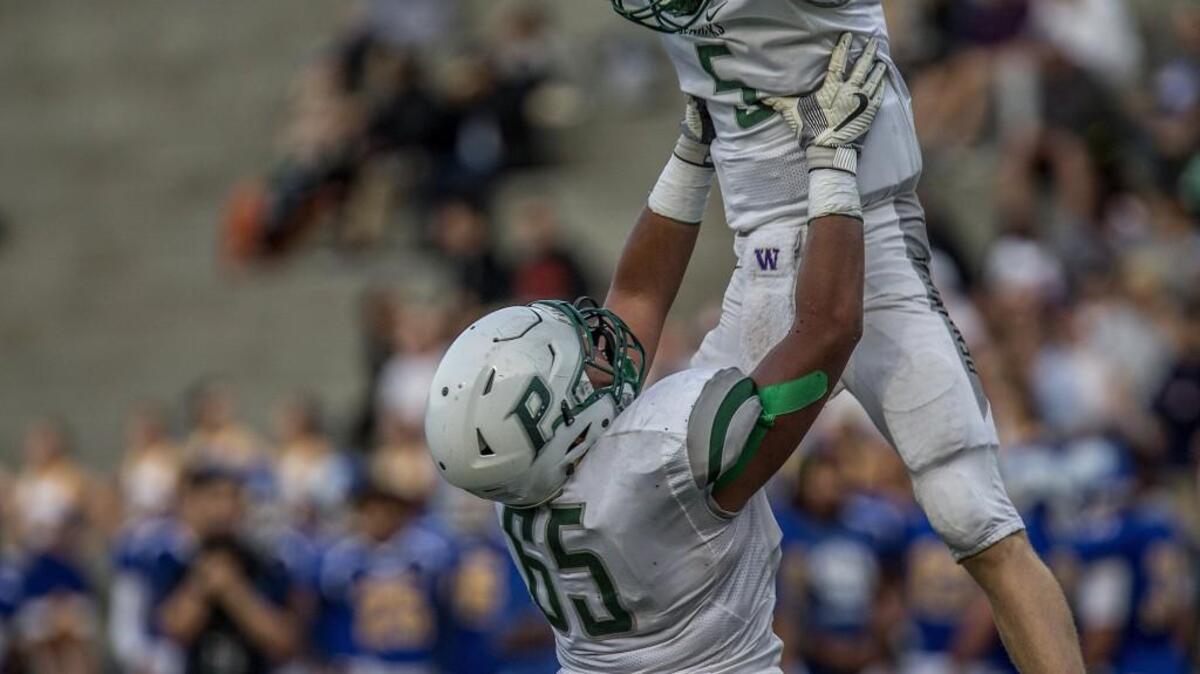 Peninsula quarterback Burke Griffin (5) celebrates a touchdown in the first quarter of the Seahawks game against Stadium High School on Friday night at Stadium Bowl in Tacoma.