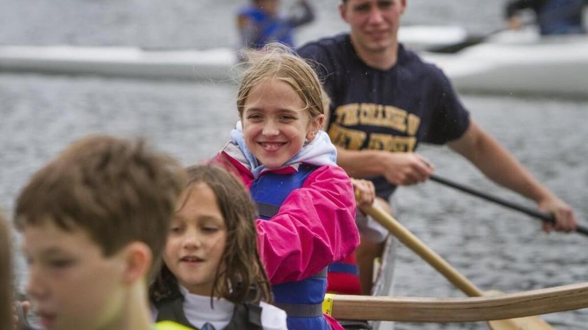 Students including Kate Gerth, 10, center, paddle out on an outrigger canoe in Gig Harbor last week.