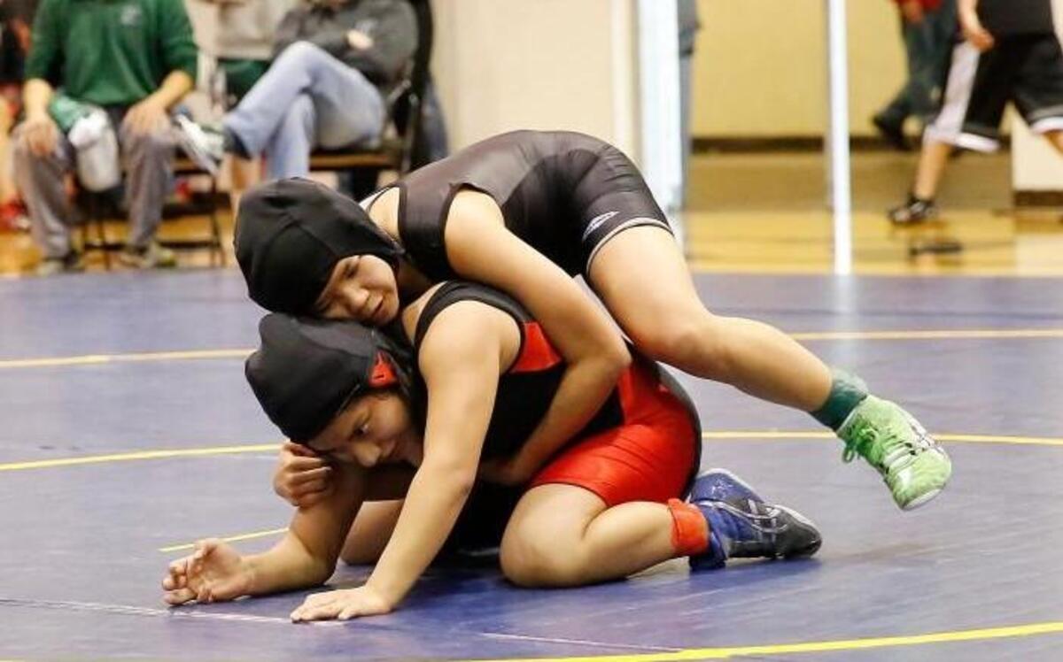 Peninsula freshman Lani Vongsey, top, won the Kentwood Invitational over the weekend in the 120-pound weight class.