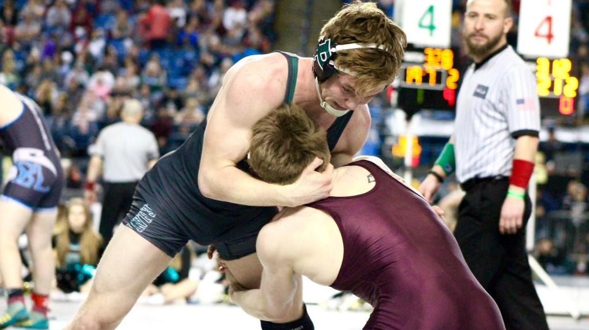Peninsula’s Isaac Casey, top, wrestles O’Dea’s Alan Bradley in the Mat Classic state tournament at the Tacoma Dome.