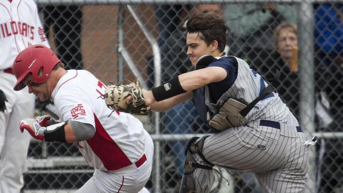 Gig Harbor’s Jon Burghardt tags out Mount Si’s Harrison D’Anna at the plate during the second inning of their baseball game at Heritage Park in Puyallup, Wash., on Saturday, May 21, 2016.