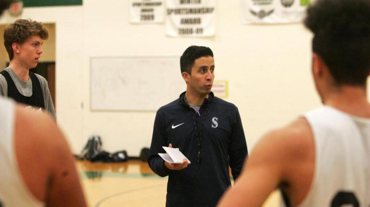 Peninsula coach Matt Robles addresses the team before practice Monday.