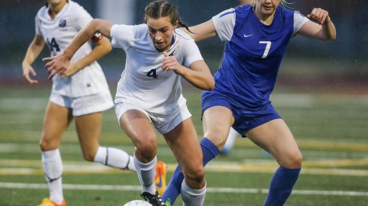 Gig Harbor's Carolyn Merrick, 4, keeps possession away from Stadium's Samantha Putnam, 7, in the first half of last year’s district playoff game.
