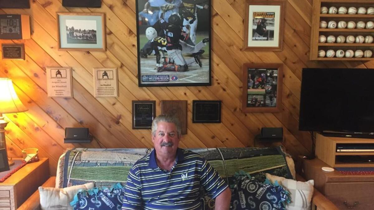 Longtime little league and local high school baseball umpire Joe Winniford, who has been actively involved with the Gig Harbor community, sits in his home office with some of the accolades and memorabilia he has collected over the years.