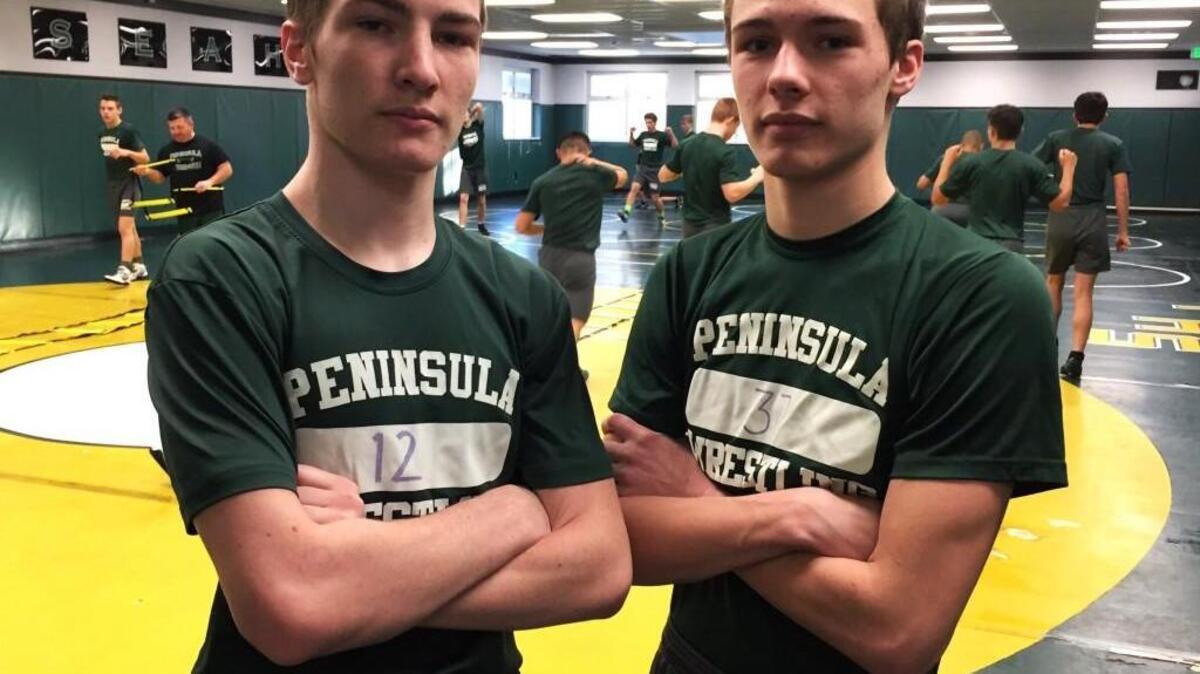 Peninsula’s Gavin Allen, left, and brother Brock share a friendly sibling competition in practice on the wrestling mat.