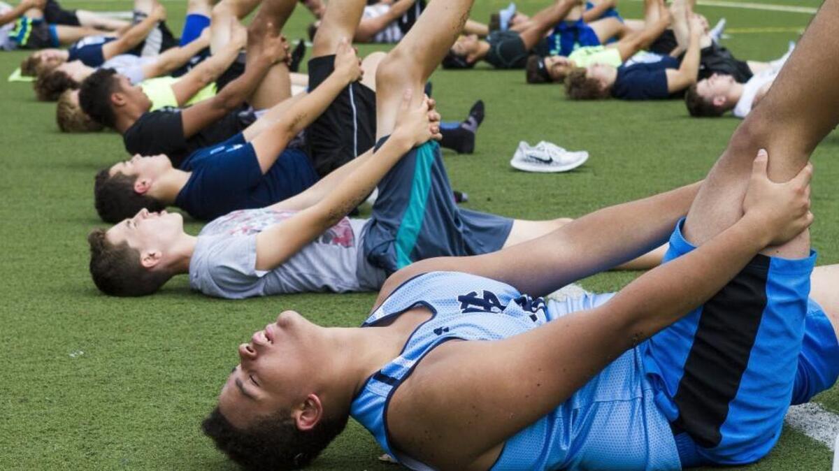 Gig Harbor High School football players stretch their legs in yoga class on Monday at Gig Harbor High.