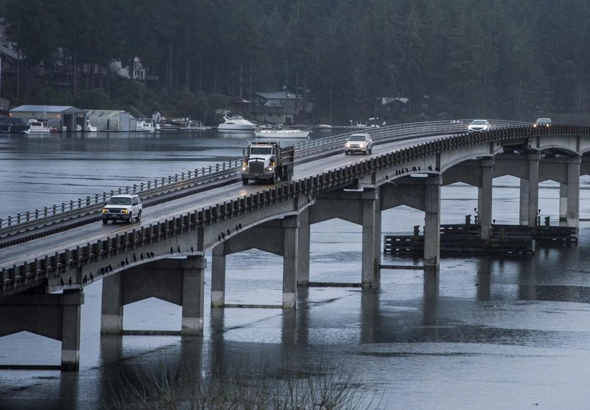 Cars drive along the bridge connecting Gig Harbor and Fox Island. The bridge is the only way to and from the island.