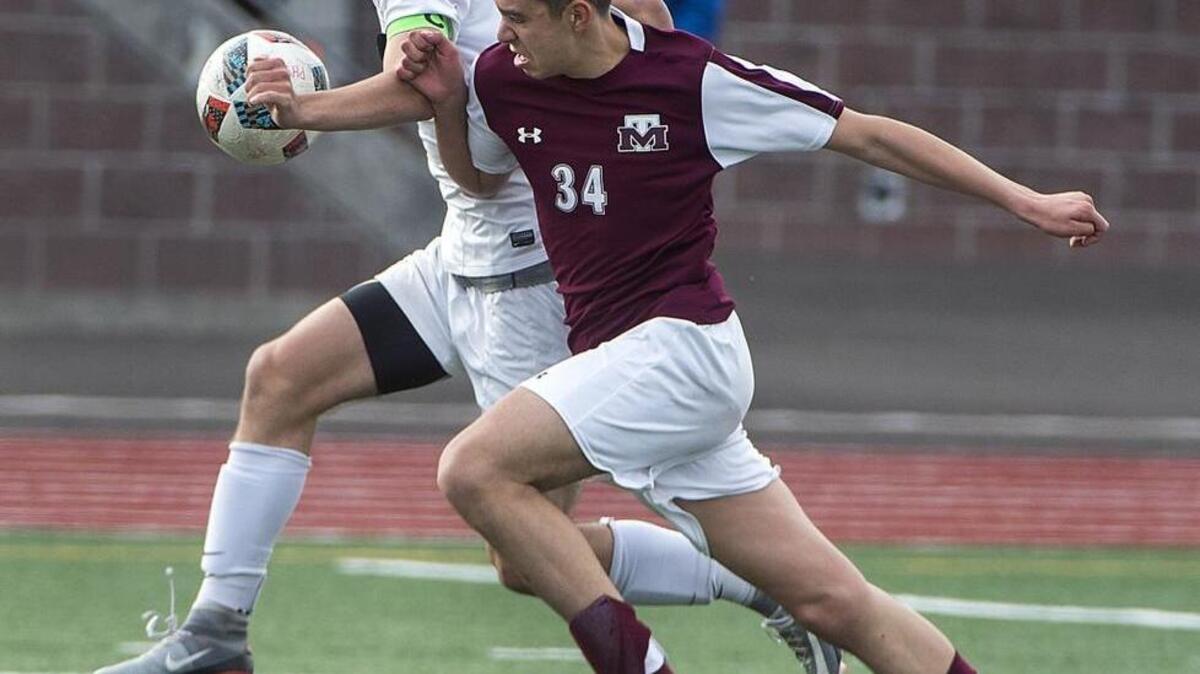 Mt. Tahoma's Mason Karatur, right, battles for possession with Peninsula's Mason Haubrich, who scored the Seahawks' third goal to make the final score 3-0.