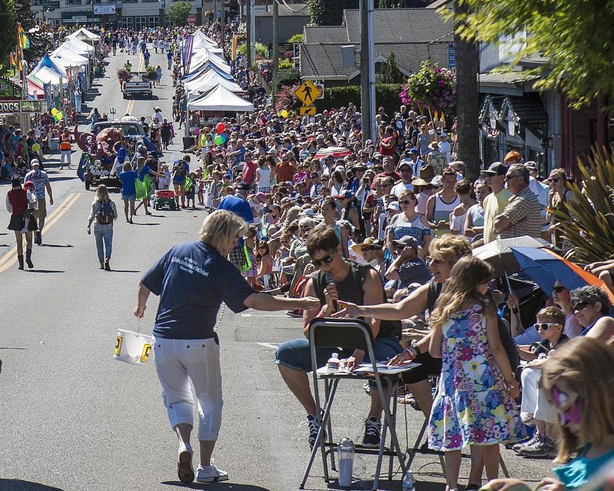 People gather along the sidewalk for the Yo’ Ho’ Harbor Grande Parade in Gig Harbor, Wash., on Saturday, June 4, 2016.