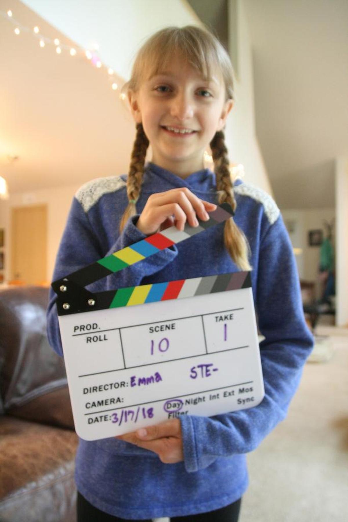 Annie Stafki, 9, shows off her new clapboard her parents gave her. The clapboard is one of many professional tools Annie, her sister Emma and friends are using to film their movie for the Gig Harbor Film Festival’s 72-hour Film Competition.
