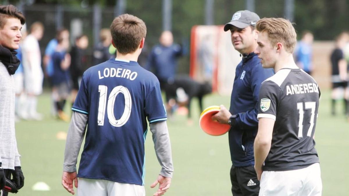 Former assistant Joe Ross, talking with players at Monday’s practice, is taking over as the head coach of the Gig Harbor Tides boys’ soccer team.