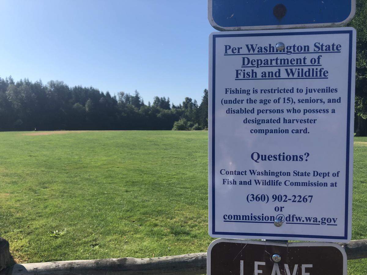 A sign posted at Bradley Lake Park in Puyallup reminds visitors that only juvenile, senior and disabled fishermen can fish there. The fishing regulations changed on July 1, 2018.