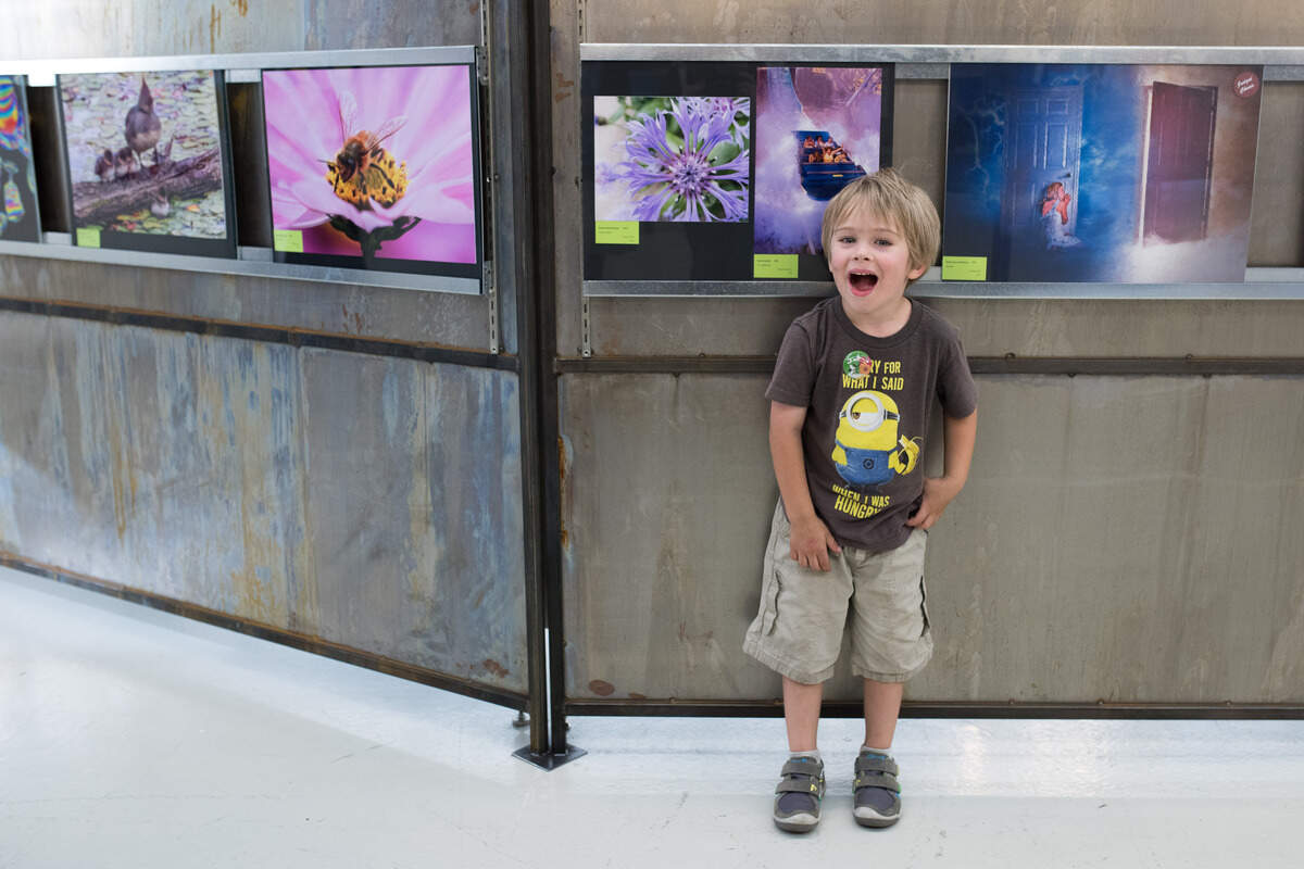 Garvan MacFarlane, 5, stands beside his photograph, “Purple Petals,” that was accepted into the Youth Division at the Washington State Fair’s photo contest. Sept. 7, 2018