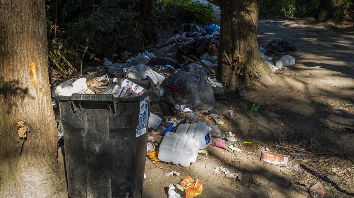 Trash from a homeless camp is seen piled near the Puyallup River on Aug. 1. The Washington State Department of Transportation, along with city of Puyallup officials, has moved to resettle the homeless encampment along the Puyallup River.