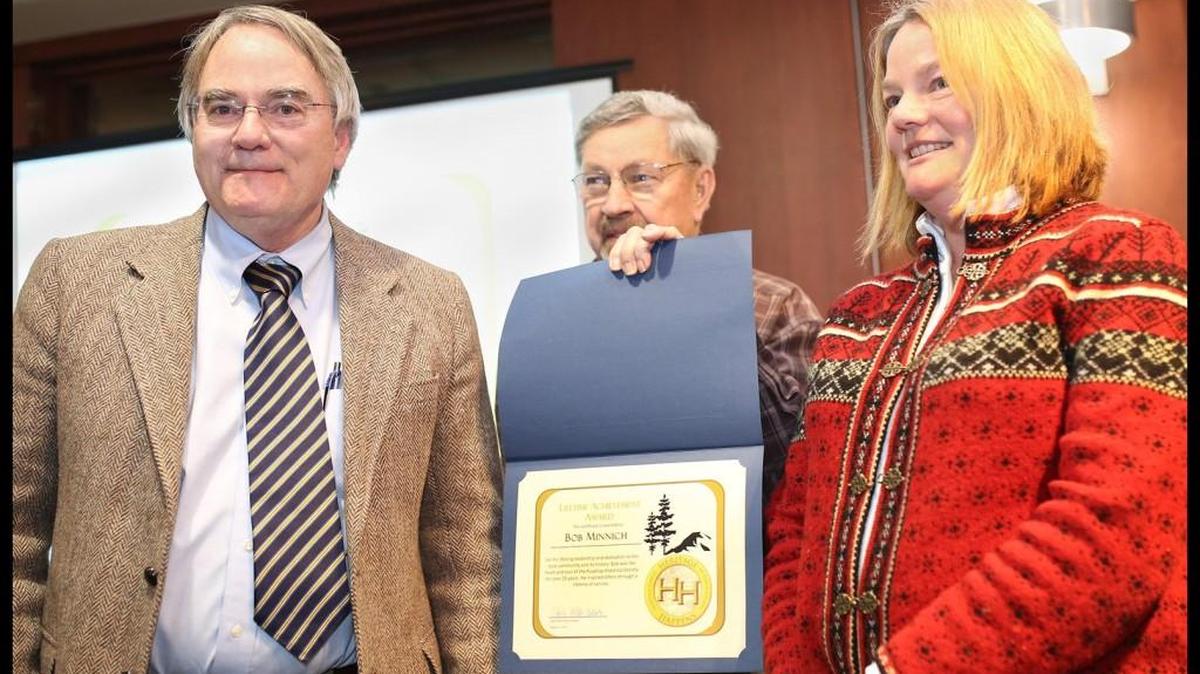 Wes Perkinson, center, treasurer of the Pierce County Heritage League, presents the Posthumous Lifetime Achievement for Heritage Preservation to the late Bob Minnich, former Puyallup Historical Society president who died in June. Minnich’s siblings, Sam Minnich, left, and Liz Anderson accepted the award on his behalf at the annual Heritage League meeting on Feb. 3 at the Washington State History Museum.