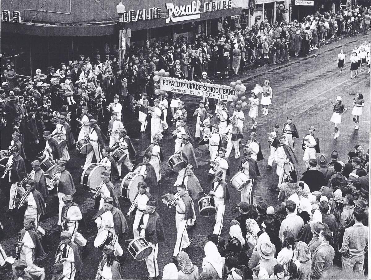 A photo taken in the 1950s shows the Daffodil Parade passing Beall’s Rexall Drugs. The pharmacy, now Beall’s Compounding Pharmacy, is closing its doors this month.