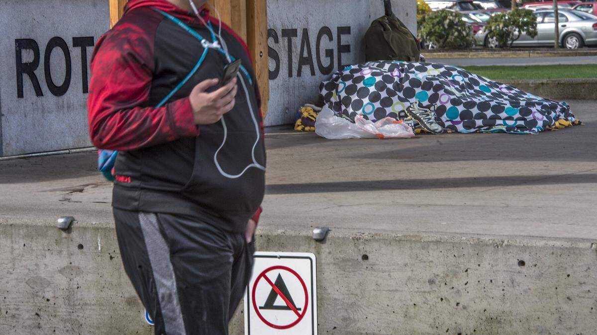 A homeless citizen sleeps on the Rotary Pavillion concrete March 31, 2017 in Puyallup’s Pioneer Park.  The City Council has extended a moratorium on new homeless service providers while it continues to write new ordinances addressing homelessness.