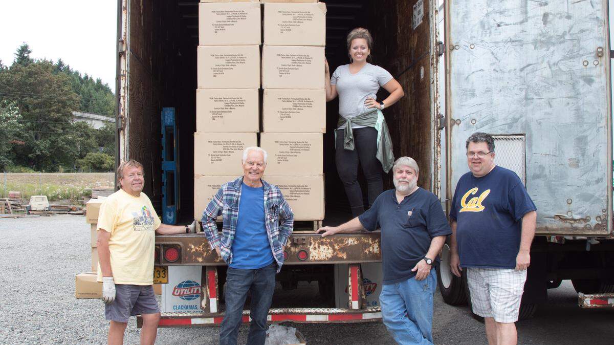 Jerry Yoder (left), Jerry Vandenberg, Natasha Gunia and Ron Haines were some of the Sumner Rotary members who picked up and distributed the $850,000 Brooks Running donation.