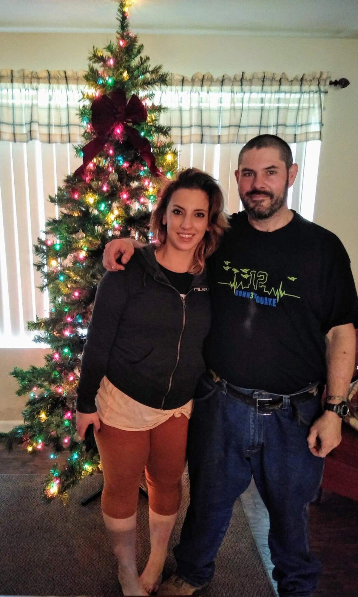 Desiree’ Almonte, left, and Kevin Booth stand in front of a Christmas tree at Almonte’s father’s house in Sumner. Almonte started a GoFundMe for Booth after he found $17,000 in cash outside of the Sumner Food Bank and returned it. The GoFundMe has raised more than $14,000. December, 2018